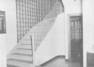 The stairway between the first and second floors near the front entrance of the Book Depository