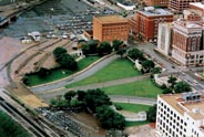 Aerial view of Dealey Plaza in Dallas Texas. Texas School Book Depository building is at center-top. The 'grassy knoll' is down and left from there. Courtesy Stewart Galanor.