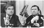 Senator Frank Church showing a poison dart gun.