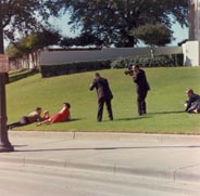 Photograph taken in the aftermath of the shooting in Dealey Plaza, looking toward the grassy knoll fence. Photo by Cecil Stoughton.