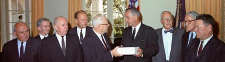 The full Commission presents the Report to President Johnson, 24 Sep 1964. From left: John MCloy, J. Lee Rankin, Richard Russell, Gerald Ford, Earl Warren, Lyndon Johnson, Allen Dulles, John Sherman Cooper, Hale Boggs.