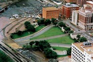 Dealey Plaza, Dallas. TSBD is in upper-middle of photo. Grassy knoll is to its left.