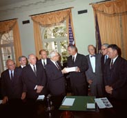 The Warren Commissioners deliver their report to President Johnson.