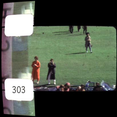 Figure 17. Mary Moorman and Jean Hill standing in the grass as the limousine passes